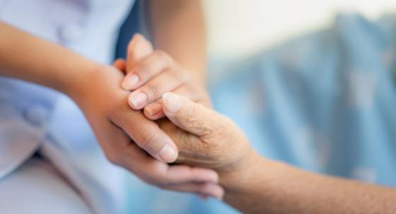 An aged care worker and patient (Image: Adobe)